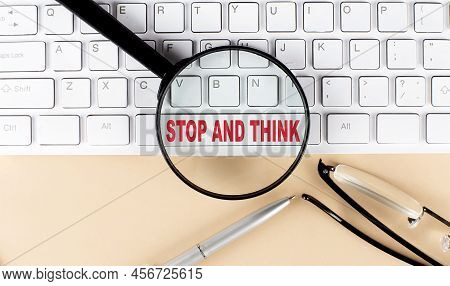 Text Stop And Think On Keyboard With Magnifier , Glasses And Pen On A Beige Background