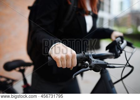 Close-up Of Businesswoman Commuter On The Way To Work With Bike, Holdinh Handles, Sustainable Lifest