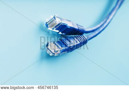 Blue Ethernet Cable Cord Patch Cord On A Blue Background With Free Space