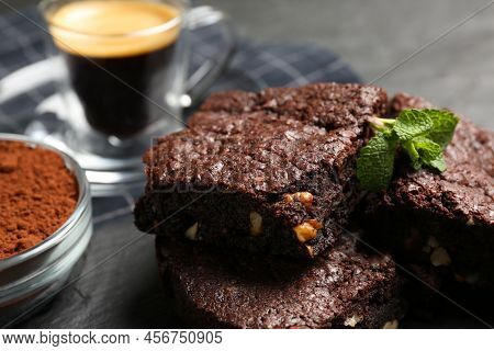 Delicious Chocolate Brownies With Nuts And Fresh Mint On Table, Closeup