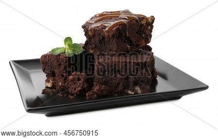 Delicious Chocolate Brownies With Nuts, Caramel Sauce And Fresh Mint On White Background