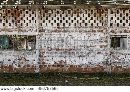 Wall With Exposed Bricks, In The Color Of Clay, With A Light White Paint Already Faded By Time. Abov