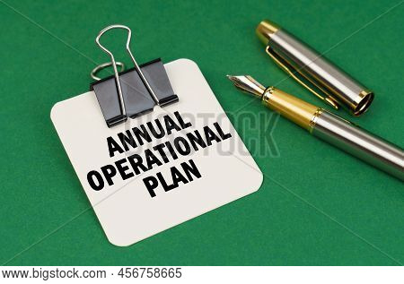 Business And Industry Concept. On A Green Surface, A Pen And A Sheet Of Paper With The Inscription -