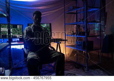 Anonymous Hacker In Military Unifrorm On Dark Web, Cyberwar Concept.
