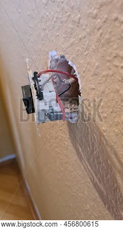 Close-up Mounting Electric Light Switch In Wall Box.