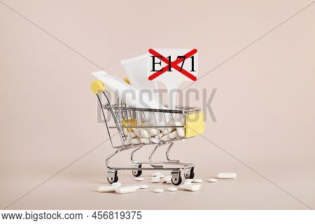 Titanium Dioxide, E171, Dangerous Additive Concept. Gum, Pills, Toothpaste, Cream In Basket And Sign