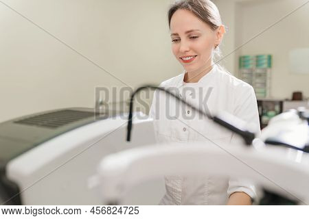 Doctor Examines Eyes On Screen Of Autorefractometer.
