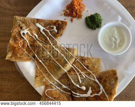 Aloo Paratha Or Indian Potato Stuffed Flatbread. Served With Fresh Curd And Chutneys. Selective Focu