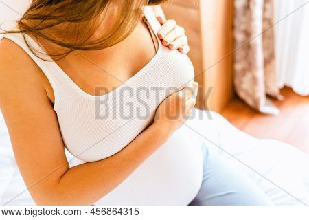 Breast Exam Cancer Pregnancy Woman Check. Happy Young Pregnant Woman Self Exam. Breast Self Exam. He
