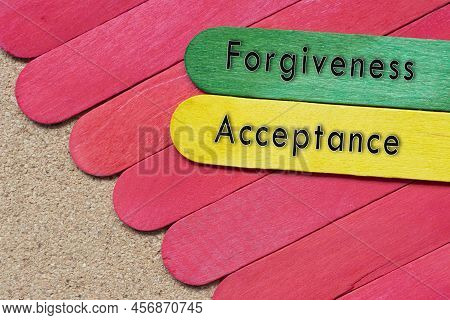 Forgiveness And Acceptance Words On Colorful Wooden Sticks On Wooden Desk.