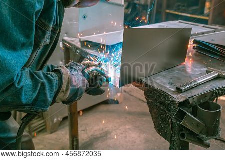 The Welder Works With Metal At The Factory