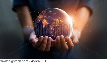 Earth At Night Was Holding In Human Hands. Earth Day. Energy Saving Concept, Elements Of This Image 