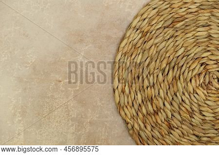 Dried Grass Straw Circular Woven Matt On Vintage Worn Background
