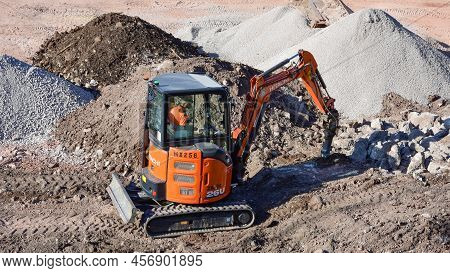 Prestatyn, Uk. Jun 22, 2022. A Worker Operates A Mini Digger On The Construction Site Of A New Home 