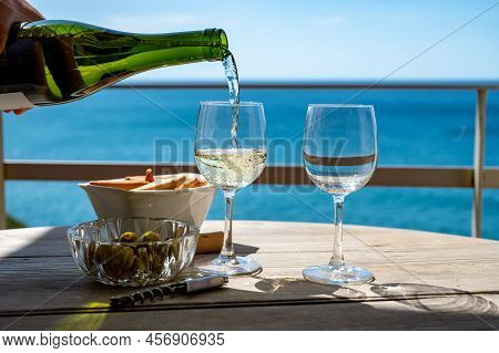 Pouring Of Txakoli Or Chacolí Slightly Sparkling Very Dry White Wine Produced In The Spanish Basque