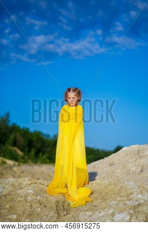 Ukrainian Patriot Girl In A Yellow Dress Against A Blue Sky. Summer Photo. Blue Sky. Sunny Day. Free