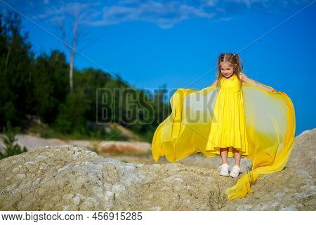 Ukrainian Patriot Girl In A Yellow Dress Against A Blue Sky. Summer Photo. Blue Sky. Sunny Day. Free