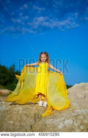 Ukrainian Patriot Girl In A Yellow Dress Against A Blue Sky. Summer Photo. Blue Sky. Sunny Day. Free