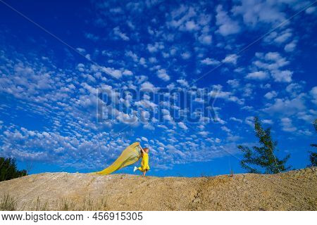 Ukrainian Patriot Girl In A Yellow Dress Against A Blue Sky. Summer Photo. Blue Sky. Sunny Day. Free