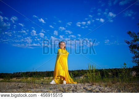 The Symbol Of Freedom Is A Ukrainian Girl Of 7 Years Old, Patriotically Dressed In A Yellow Dress Ag