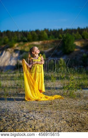 The Symbol Of Freedom Is A Ukrainian Girl Of 7 Years Old, Patriotically Dressed In A Yellow Dress Ag