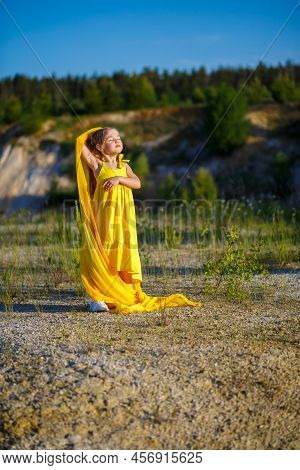 The Symbol Of Freedom Is A Ukrainian Girl Of 7 Years Old, Patriotically Dressed In A Yellow Dress Ag