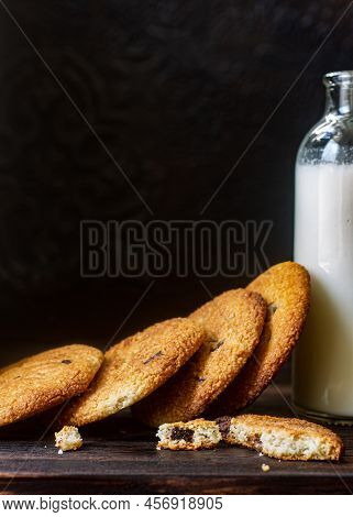Peanut Cookies With Chocolate And Glass Bottle Of Milk. Lowkey Photo.