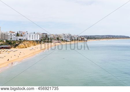 Armacao De Pera Algarve Portugal. Beautiful View On Atlantic Ocean At Day Time And City. High Qualit