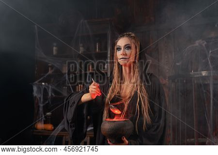 Halloween, Witch Use Magic Book And Cauldron Prepare Poison Or Love Potion. Black Magic Occult Femal
