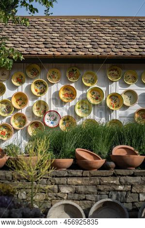Enamelware Used Basin With Patterns On Wooden Wall Of House Used As Decoration. Reusing Used Items I