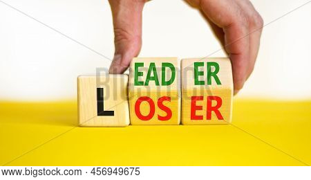 Loser Or Leader Symbol. Concept Words Loser Or Leader On Wooden Cubes. Businessman Hand. Beautiful Y