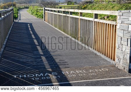 Prestatyn, Uk: Mar 27, 2022: A Wooden Footbridge On The Outskirts Of Prestatyn Is Dedicated To Thoma