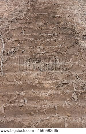 Wheel Tracks On The Soil. Tire In The Sand Or Mud. Tire Trace Tracks Car On A Soil. Rural Road In Fo
