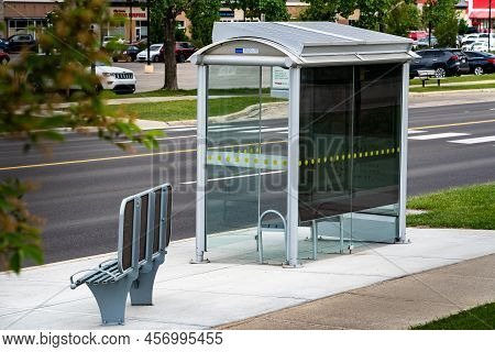 Airdrie Alberta Canada, June 12 2022: Bus Stop Transit Shelter With Solar Panels On The Roof For Sus