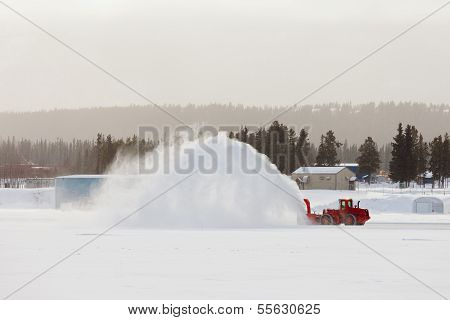 Snow Blower Clearing Road In Winter Storm Blizzard