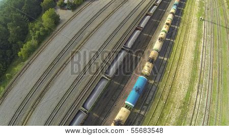 Freight trains on railways at sunny day. View from unmanned quadrocopter.
