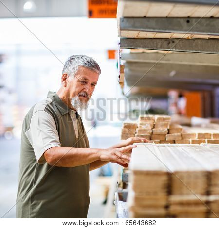 Man buying construction wood in a  DIY store for his DIY home re-modeling project