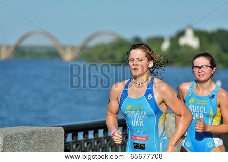DNEPROPETROVSK, UKRAINE - MAY 24, 2014: Oleksandra Gryshyna and Olena Susol run on the 3rd stage of ETU Sprint Triathlon European cup. It's the first time Triathlon European Cup take place in Ukraine