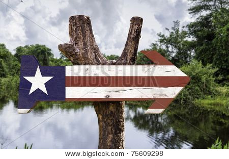 Liberia wooden sign with a forest background