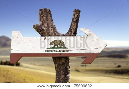 California State wooden sign with a forest on background 