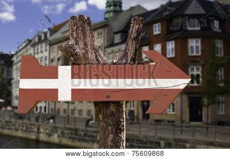 Denmark wooden sign with a view of Copenhagen on background 