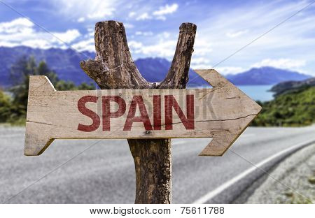 Spain wooden sign with a street background 