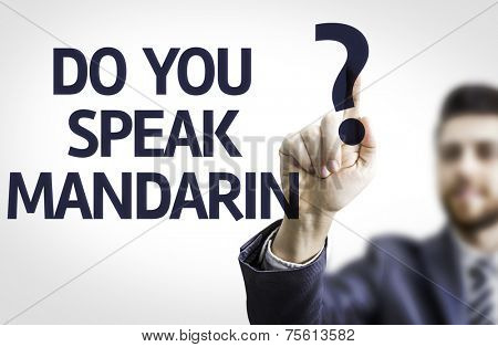 Business man pointing to transparent board with text: Do you Speak Mandarin?