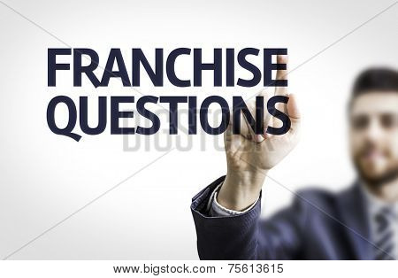Business man pointing to transparent board with text: Franchise Questions 