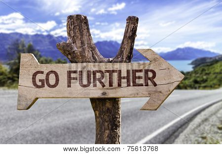 Go Further wooden sign with a paradise on background 