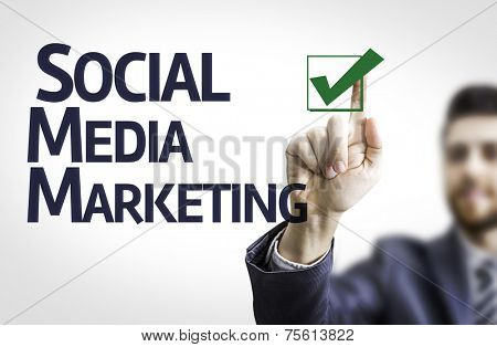 Business man pointing to transparent board with text: Social, Media, Marketing