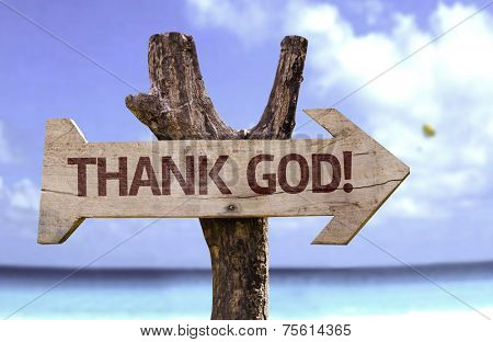 Thank God wooden sign with a beach on background