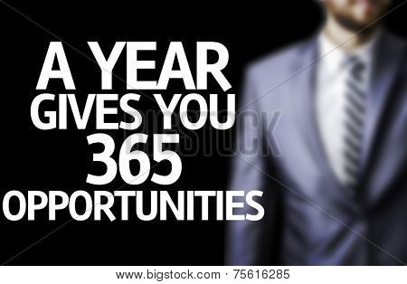 A year Gives You 365 Opportunities written on a board with a business man on background