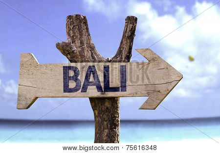 Bali wooden sign with a beach on background