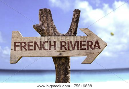 French Riviera wooden sign with a beach on background